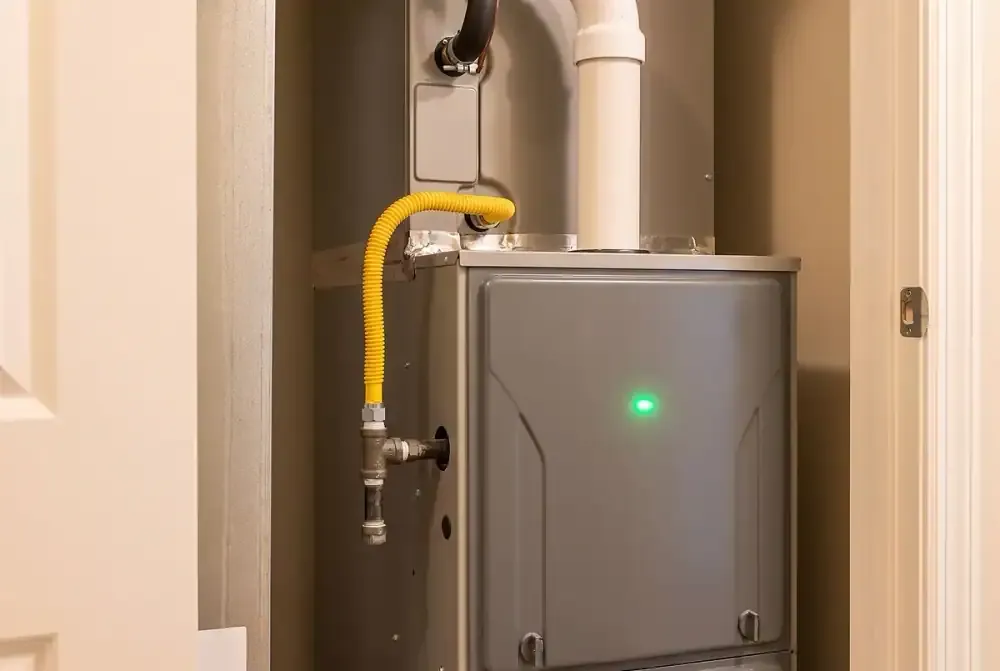 Clean modern furnace and air handler in a tidy utility closet